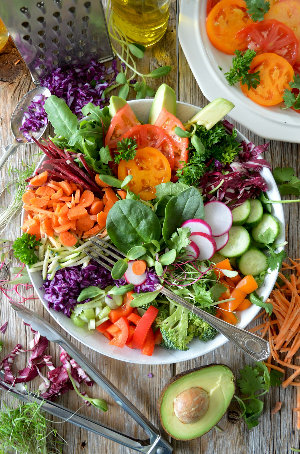 Vibrant nutrient-dense athletic salad bowl with roasted sweet potatoes, quinoa, avocado, and leafy greens