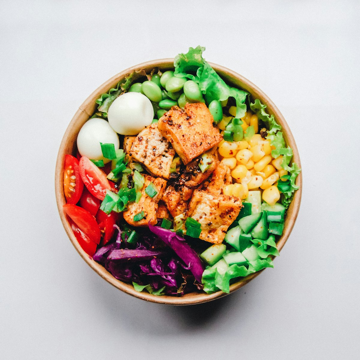 Microbiome-nourishing salad bowl with fermented kimchi, avocado, edamame, and vibrant prebiotic raw vegetables
