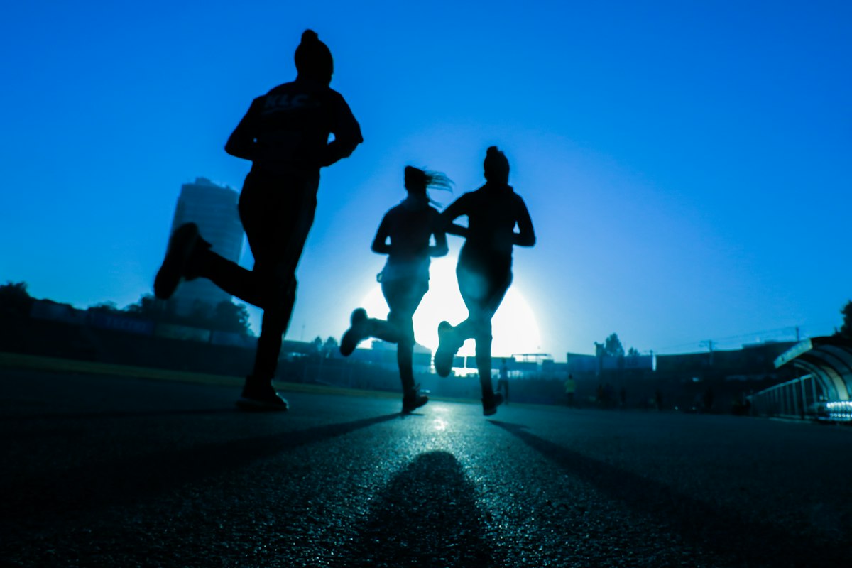Senior athletic runner training outdoors on athletic trail demonstrating longevity and peak vitality