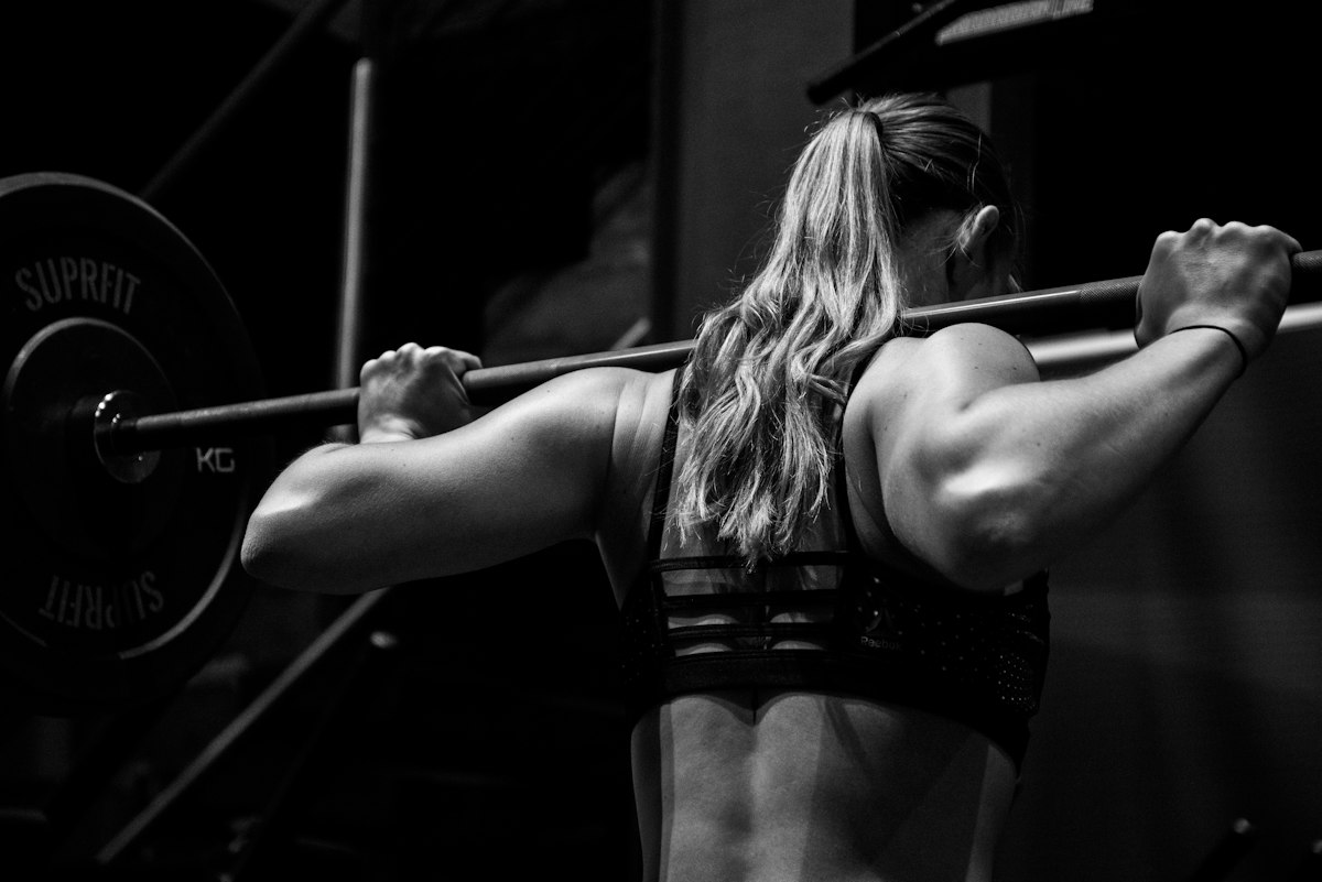 Strong athletic male executing barbell squat representing metabolic health and insulin sensitivity