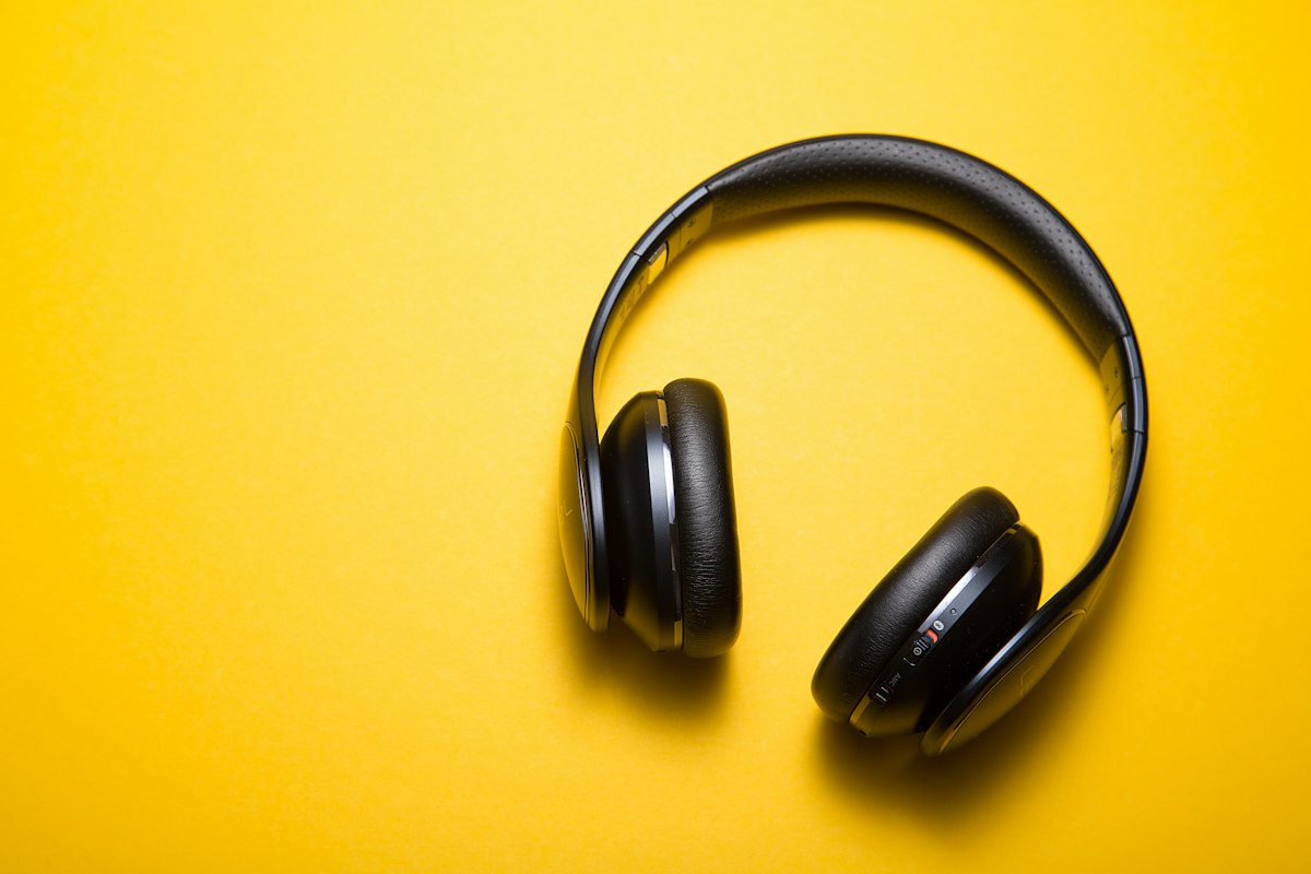 High performance wireless sports audio headphones resting on clean surface engineered for sweat resistance
