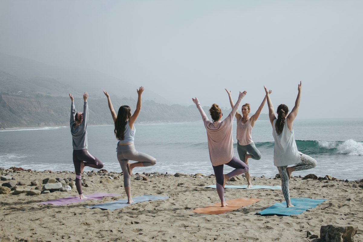Woman in peaceful yoga pose practicing focused diaphragmatic breathwork on scenic studio deck