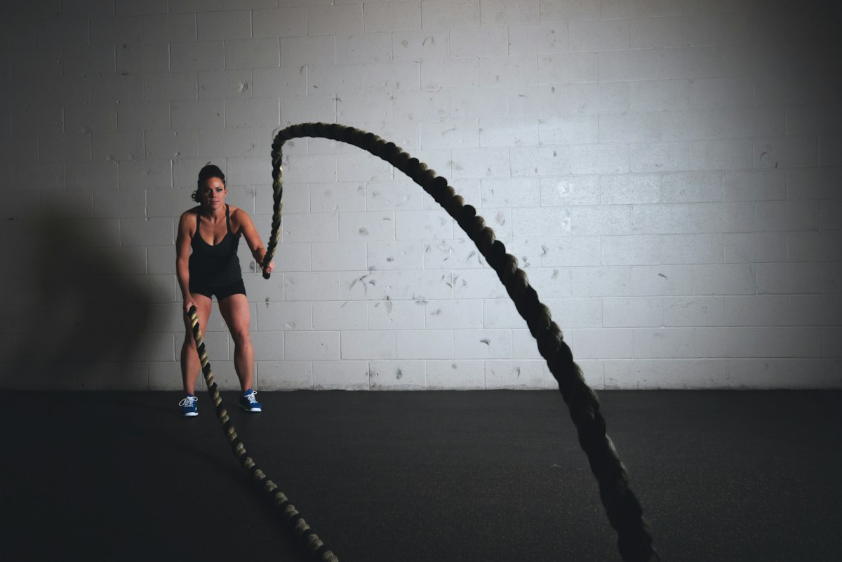 Endurance athlete running outdoors on open track at steady aerobic pace during morning sunrise