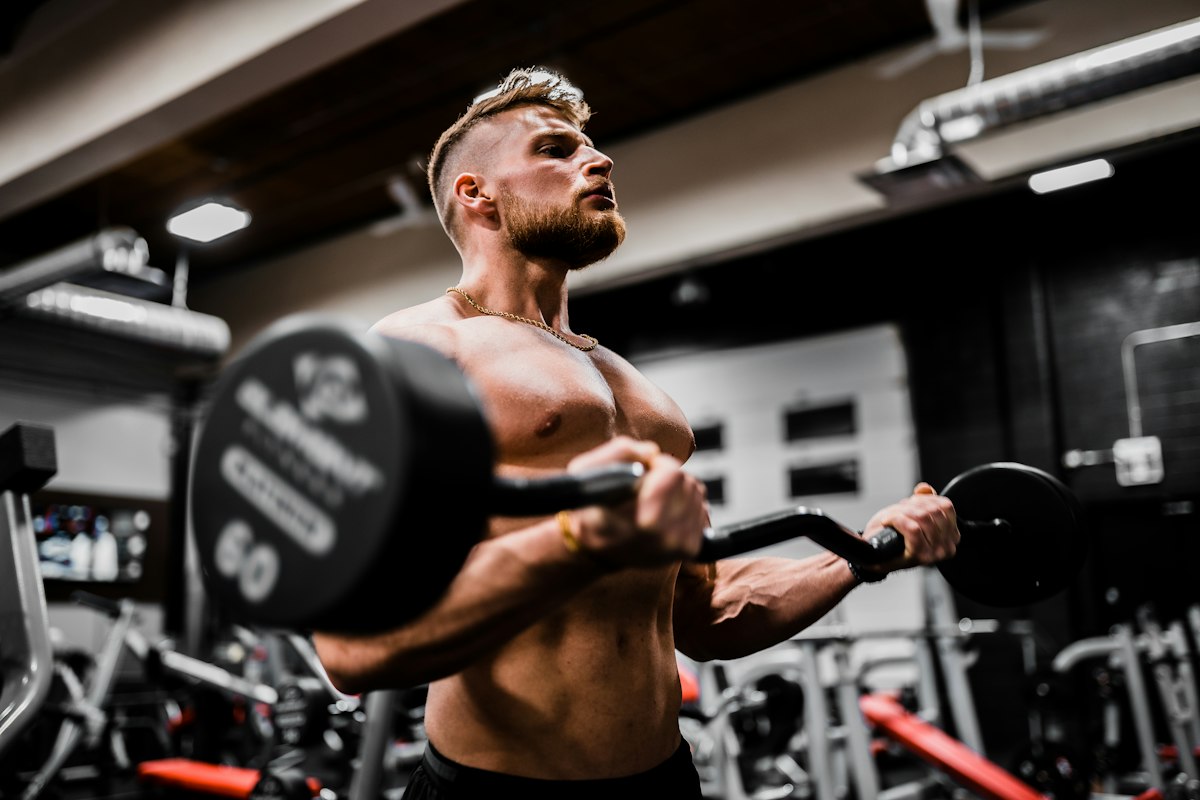 Calisthenics athlete performing disciplined pull-up repetition on outdoor park training bar